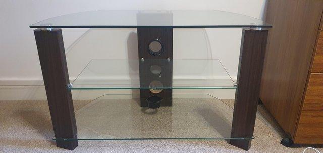 Preview of the first image of Glass and mahogany television stand.