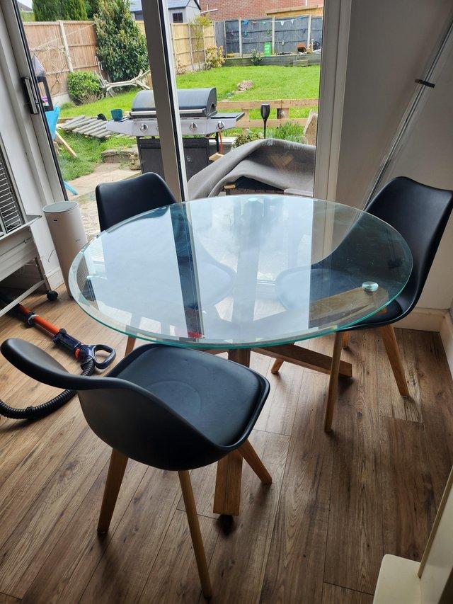 Preview of the first image of Solid oak and glass dining table and chairs.