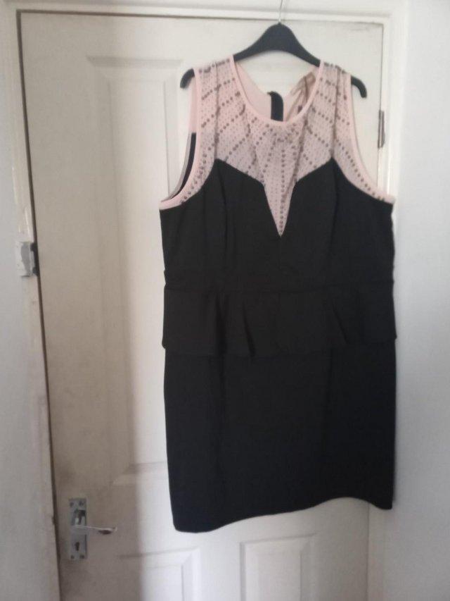 Preview of the first image of Nude Black Peplum Dress Embellish Yoke.
