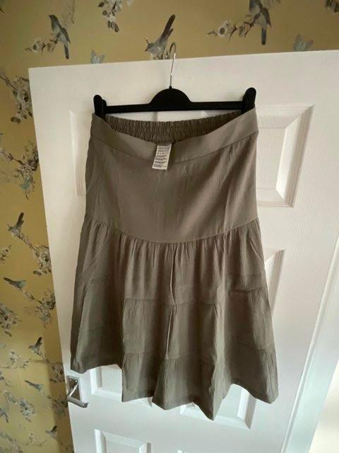 Preview of the first image of SOLD Khaki size 16 tiered skirt with back elastic aged waist.