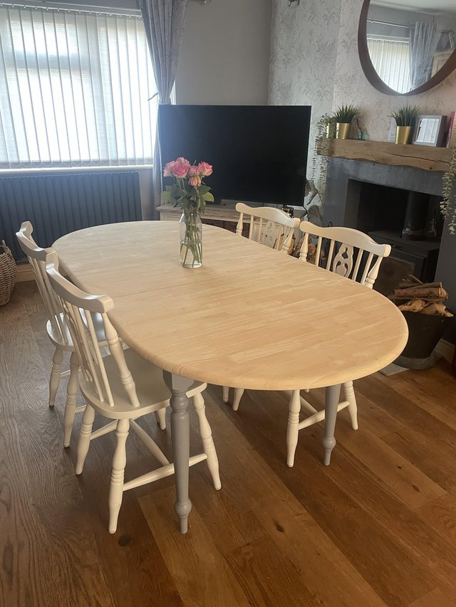 Preview of the first image of Farmhouse grey extending dining table with 4 white chairs.