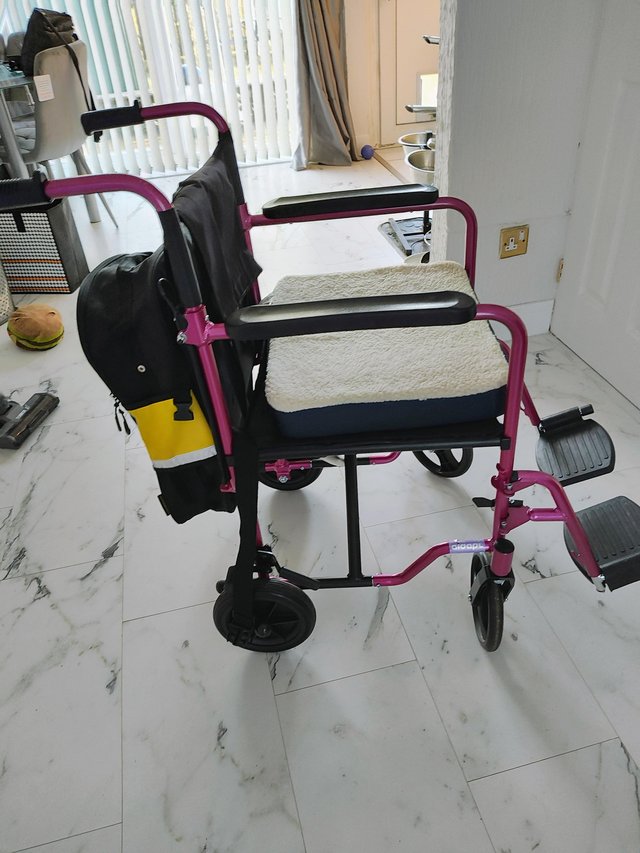 Preview of the first image of Folding transport chair with backpack and cushion.