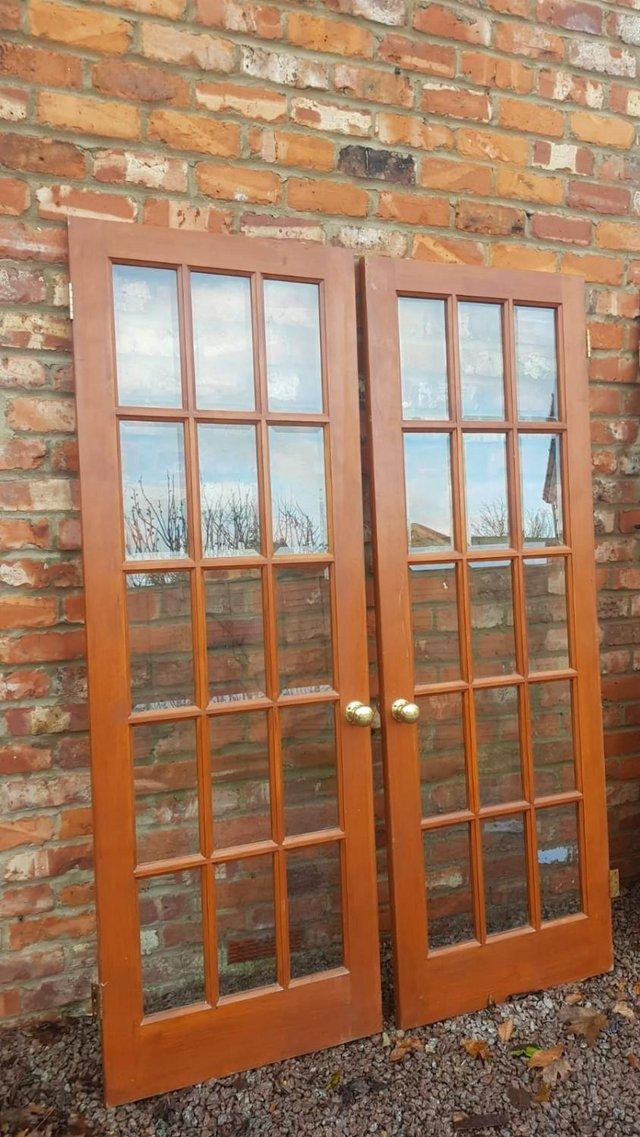 Preview of the first image of 2x Wooden Doors with Full Glass Lattice & Brass Knobs 690mm.