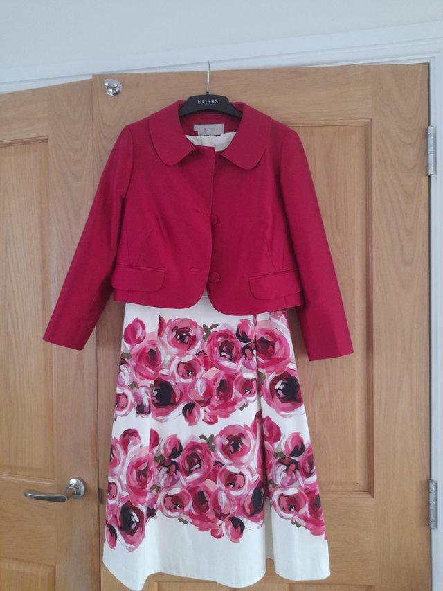 Preview of the first image of Hobbs size 10 raspberry dress and jacket with matching hat.