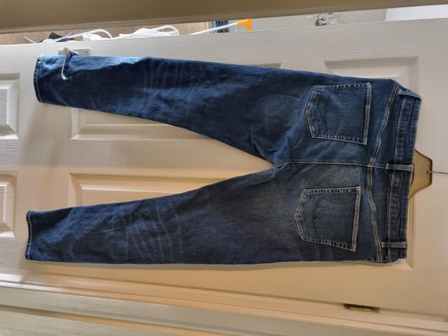 Preview of the first image of mens dark blue faded jeans W30 L32.