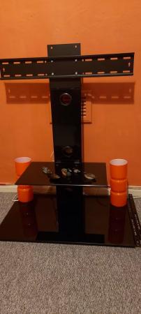 Image 1 of Smoked black glass tv stand.. in great condition.  Condition