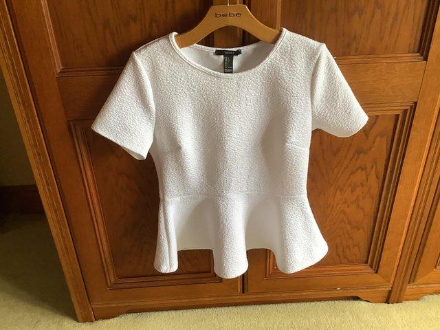 Preview of the first image of White Ladies top size says uk  L but it  fits size 10.