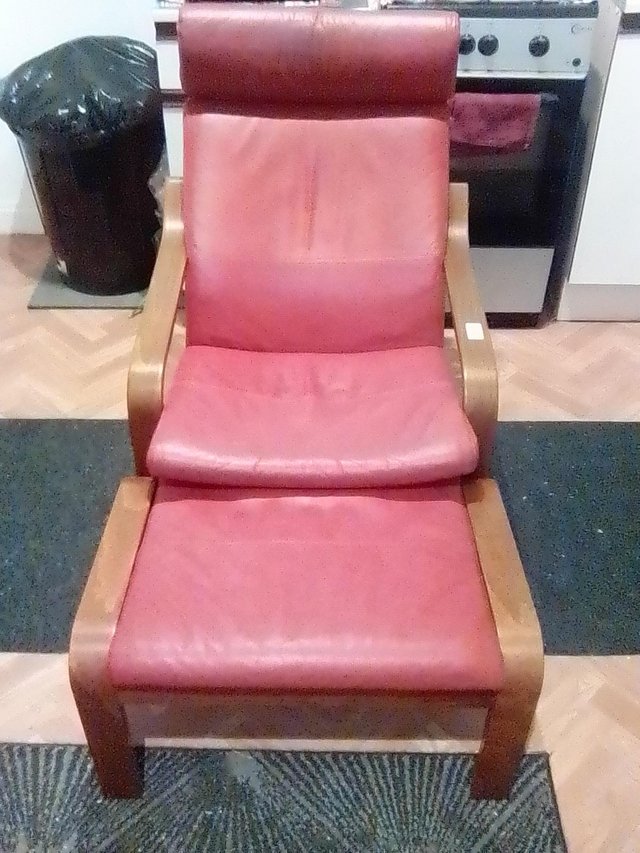 Preview of the first image of a burgundy poang chair and footstool for sale..
