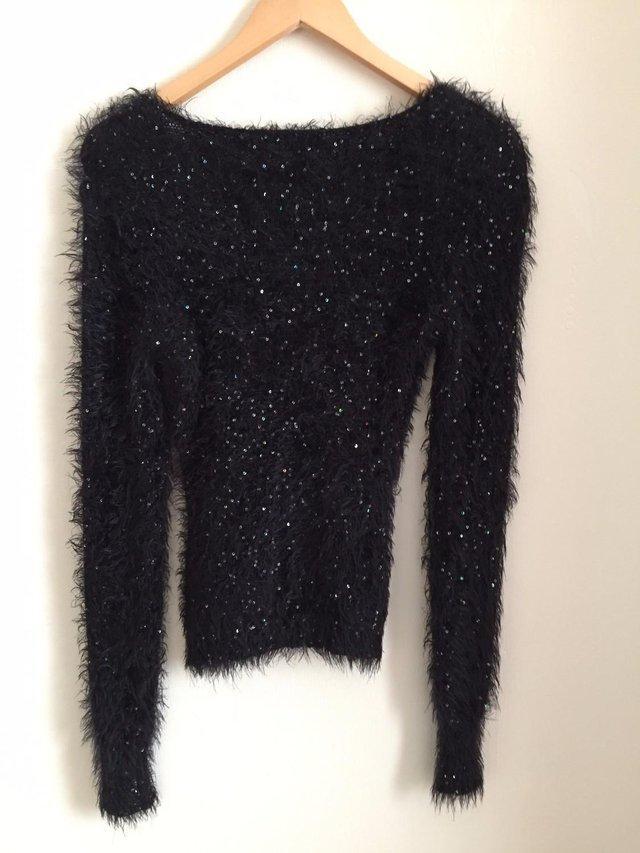 Preview of the first image of LADIES BLACK FLUFFY JUMPER………...