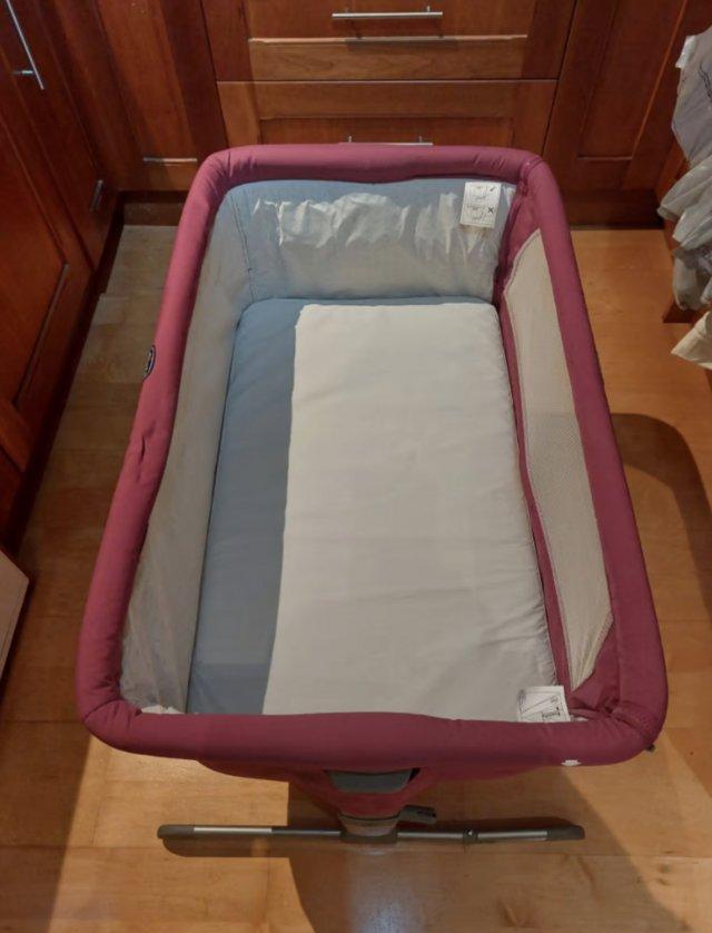 Preview of the first image of Chicco Next2Me Bed-side Crib Fuchsia Travel Cot From Birth.
