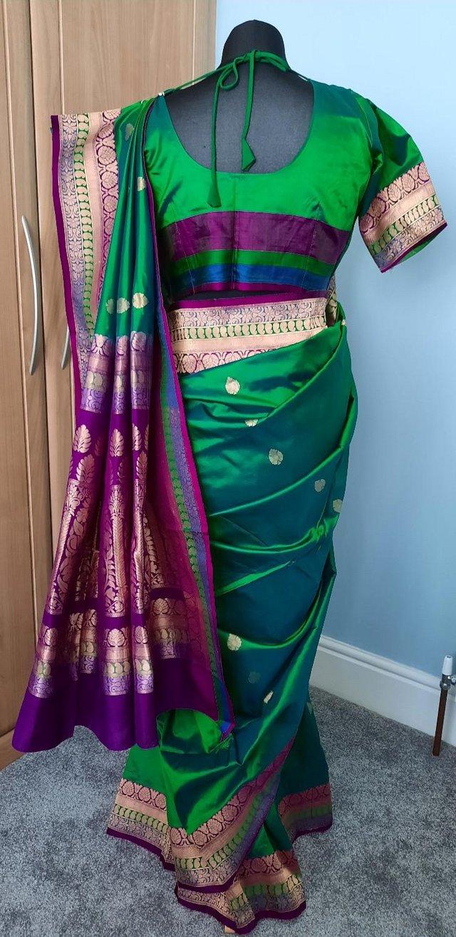 Preview of the first image of Green and purple banarasi silk saree with gold embrodiery.
