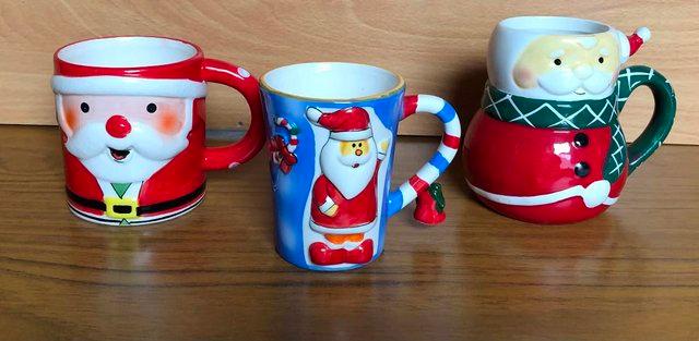 Preview of the first image of FOUR NEW FESTIVE  CHRISTMAS MUGS IN DIFFERENT DESIGNS.