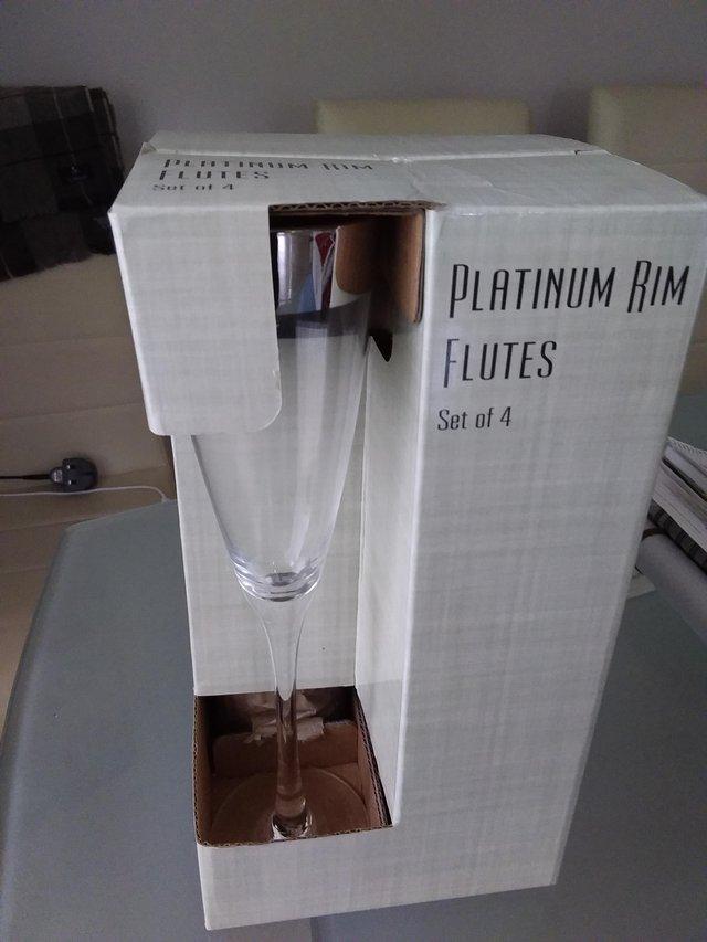 Preview of the first image of SET OF 4 PLATINUM RIM CHAMPAGNE FLUTES BOXED.