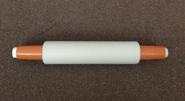 Preview of the first image of Vintage 1970's Orange/Cream Fill & Chill Rolling Pin.