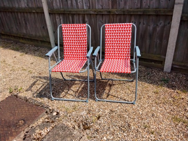 Preview of the first image of 2 orange deckchairs.Only used once.Good condition..