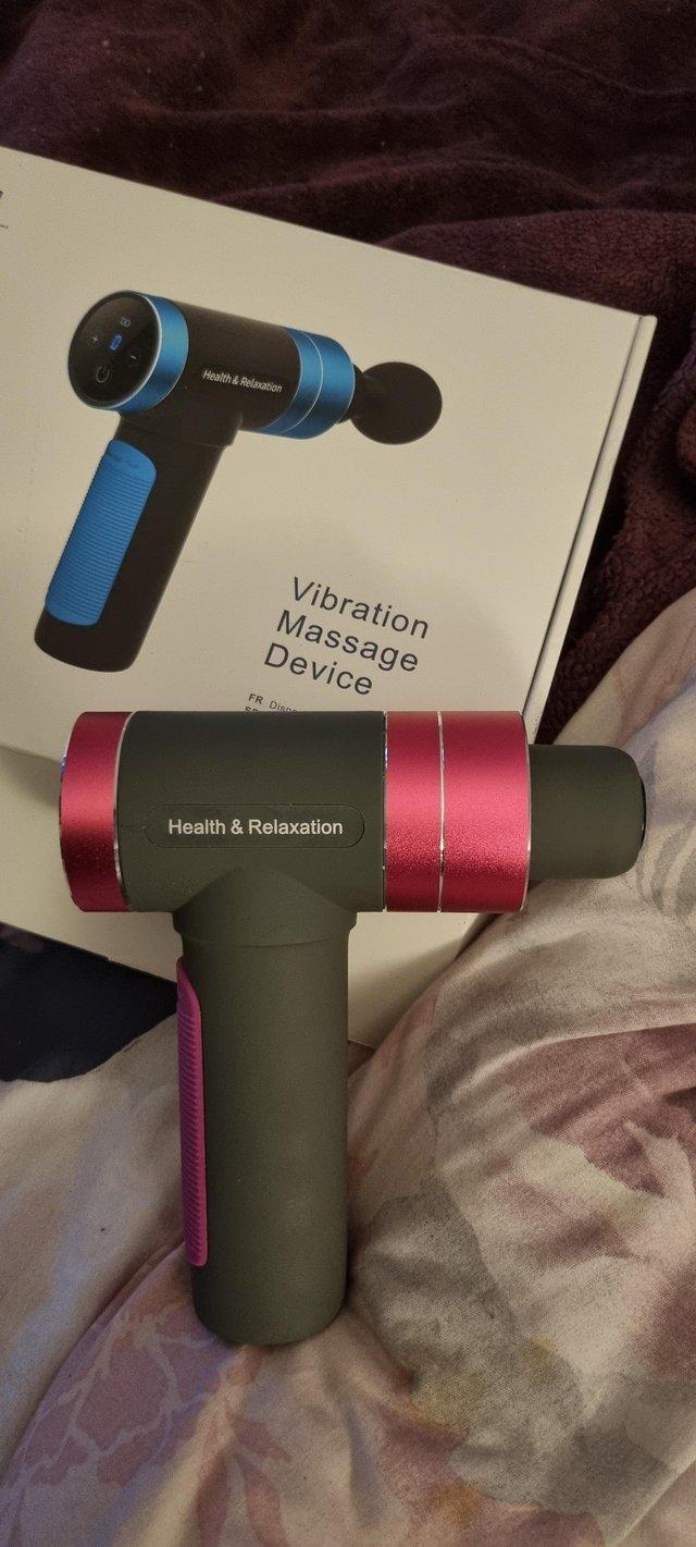 Preview of the first image of Pink and black cordless massage gun.