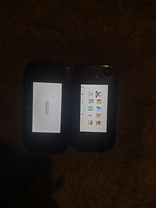 Preview of the first image of Wii u controllers in black used like new.