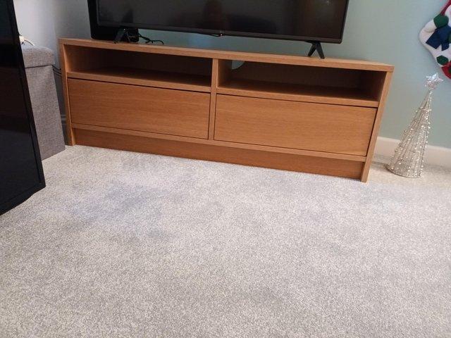 Preview of the first image of Light oak television cabinet with storage drawers.