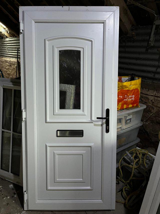 Preview of the first image of Used upvc front door letterbox and handle.