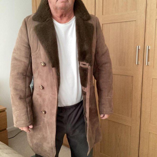 Preview of the first image of Genuine sheepskin coat and all wool black M&S coat.