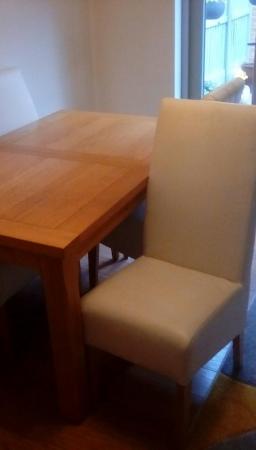 Image 2 of Extendable Oak Dining table and 4 cream leather chairs