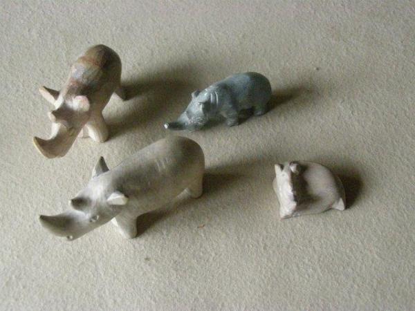 Image 1 of Four (4) stone rhinos - great Christmas gift
