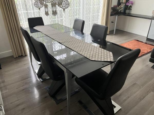 Image 1 of Black glass table with 6 chairs- good condition