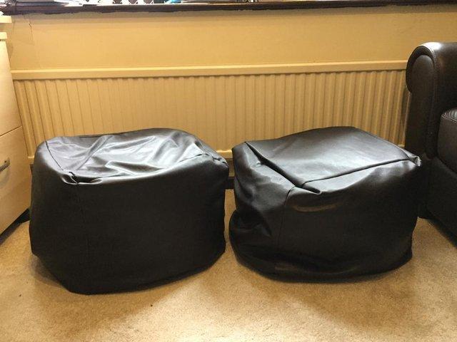 Preview of the first image of 2 Faux brown leather pouffes good condition.