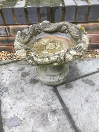 Image 3 of A two piece round concrete garden planter with animal design