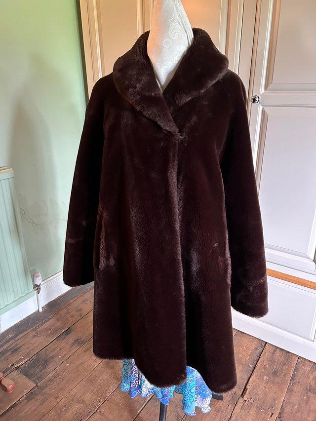 Preview of the first image of Faux Fur coat dark brown size 16.