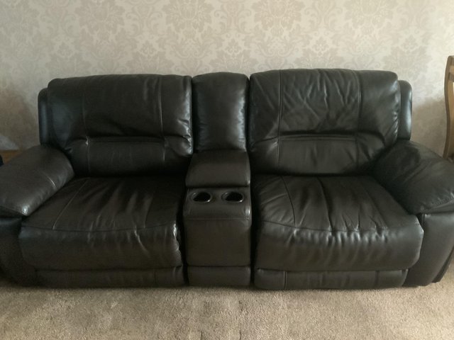 Preview of the first image of Harvey’s brown leather corner sofa with power recliners.