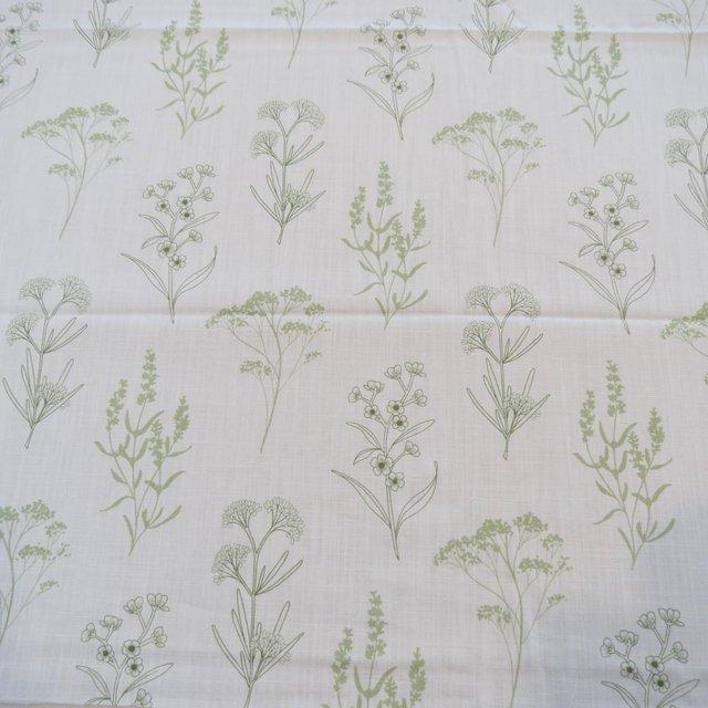 Preview of the first image of Fabric remnant  white background with green flower design.
