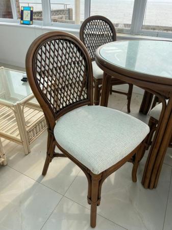 Image 2 of Cane and glass table and four chairs