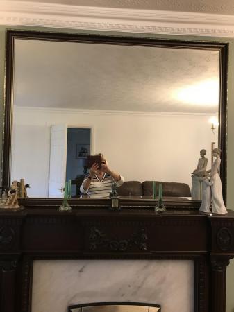 Image 1 of Large wall mirror hanging over fireplace