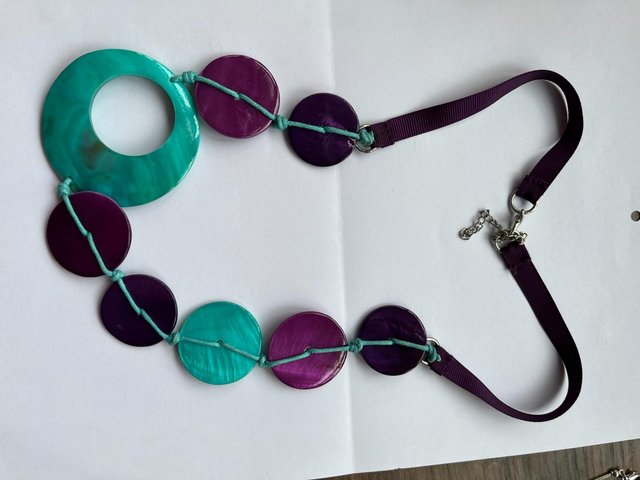 Preview of the first image of Chunky purple and turquoise shell and ribbon necklace.