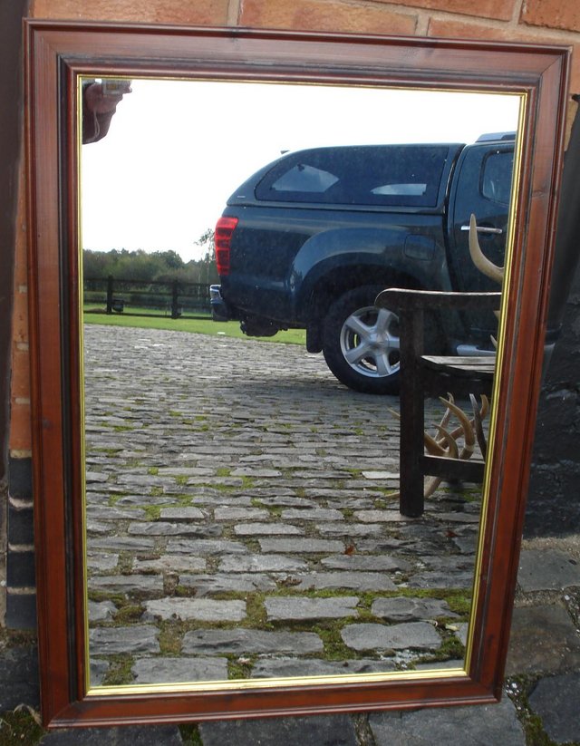 Preview of the first image of BROWN FRAMED MIRROR WITH GOLD INNER EDGING..