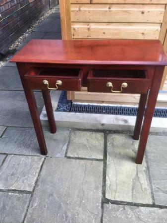 Image 3 of An attractive four legged hall table with two drawers.
