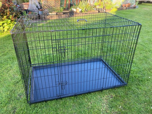 Preview of the first image of Large Dog crate in as new condition..