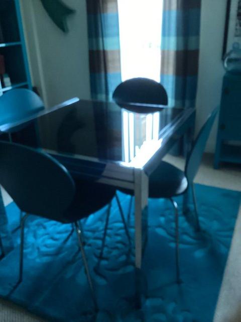Preview of the first image of Black Glass Table, 4 teal blue chairs..