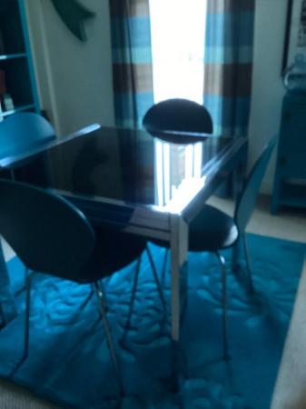Image 1 of Black Glass Table, 4 teal blue chairs.