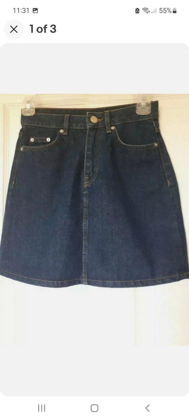 Preview of the first image of H&M Ladies Blue Denim Mini Skirt, Size 4.
