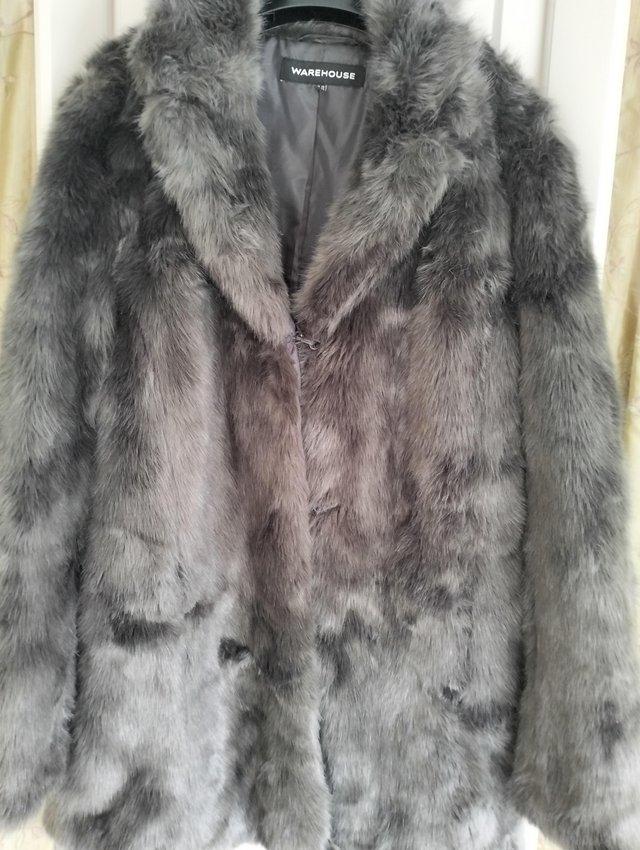 Preview of the first image of Warehouse charcoal grey faux fur coat.