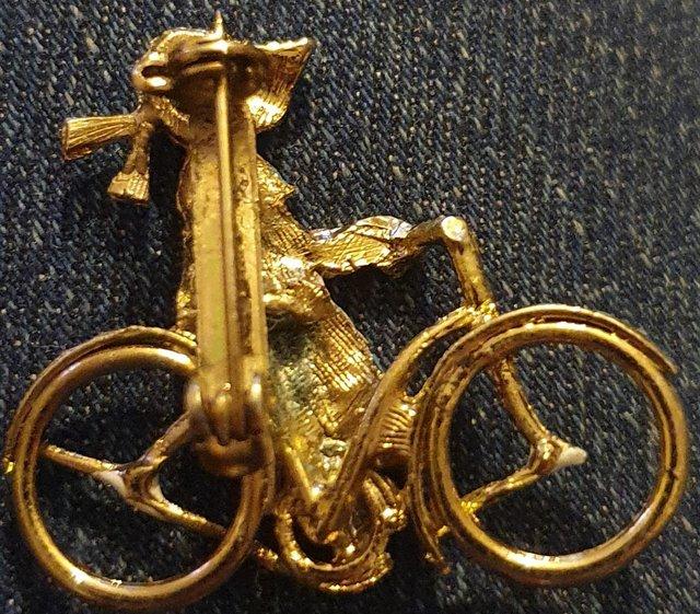 Preview of the first image of Girl on Bicycle Broach in good condition.