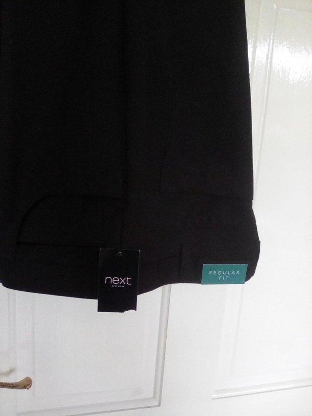 Preview of the first image of Men's black trousers never worn.