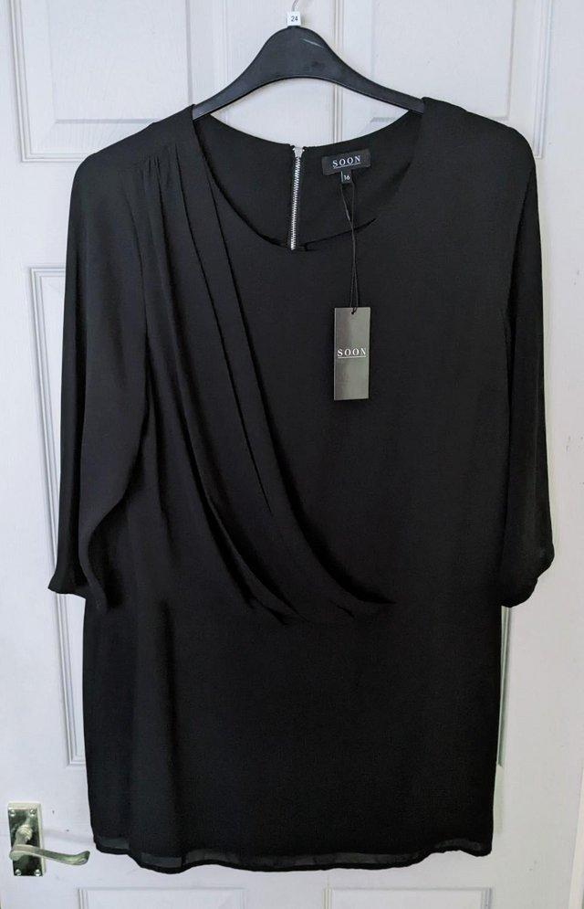 Preview of the first image of BNWT Beautiful Ladies Black Top/Dress By Soon - Size 16.