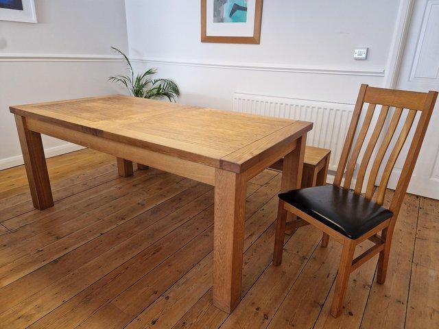 Preview of the first image of Substantial oak dining table with 6 chairs and bench.