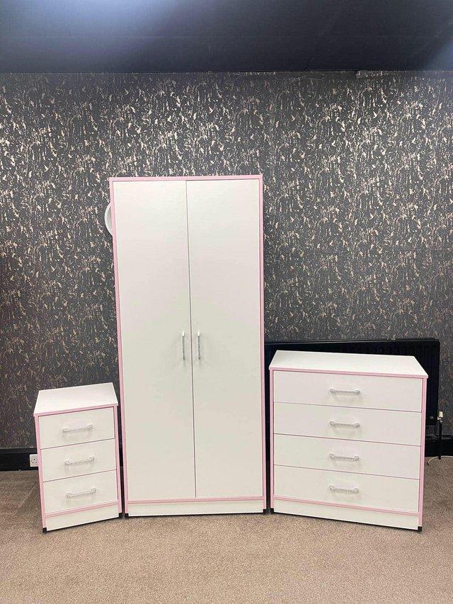 Preview of the first image of NOVA WHITE SET WITH PINK TRIM WARDROBE CHEST AND BEDSIDE.