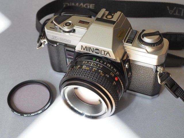 Preview of the first image of Two Minolta 35mm SLR cameras and accessories.