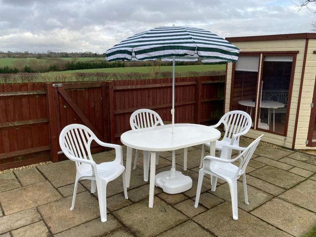 Preview of the first image of Garden table, chairs and parasol.