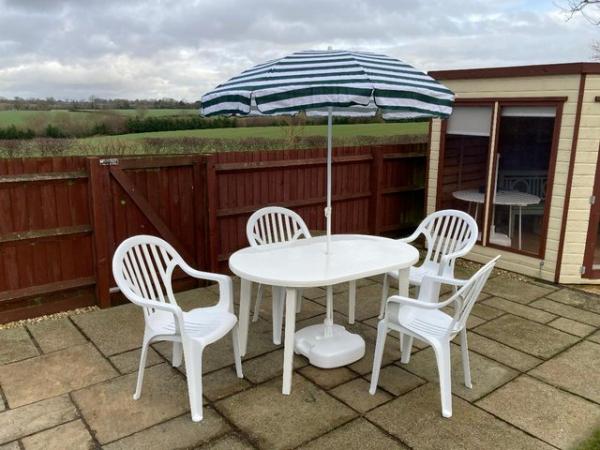 Image 1 of Garden table, chairs and parasol